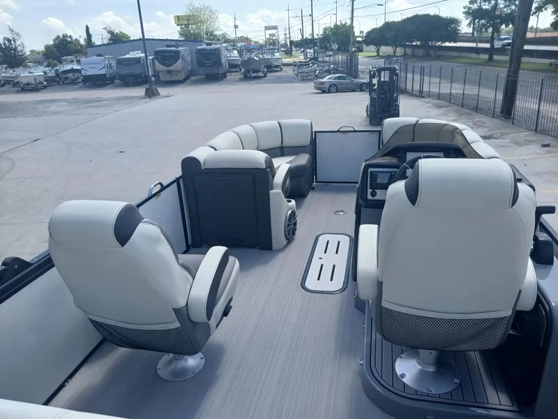 Slide: The Image of 2023 Veranda VP22VLC pontoon boat interior with plush seating and modern dashboard. - 5