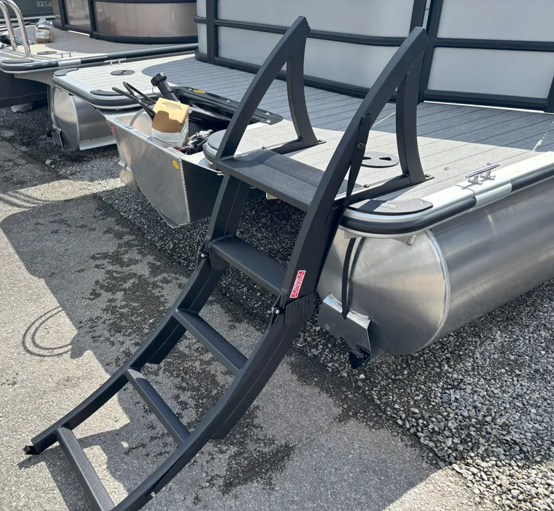 Slide: The Image of 2025 Bentley Pontoons Legacy 223 Cruise XL with ladder on gravel surface. - 12