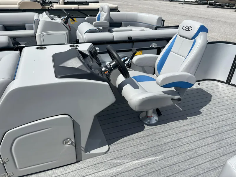 Slide: The Image of 2025 Bentley Pontoons Legacy 223 Cruise XL interior with captain's chair and control console. - 15