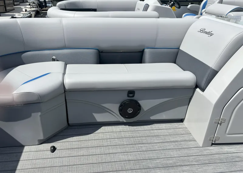 Slide: The Image of 2025 Bentley Pontoons Legacy 223 Cruise XL interior seating with sleek design and integrated speaker. - 16