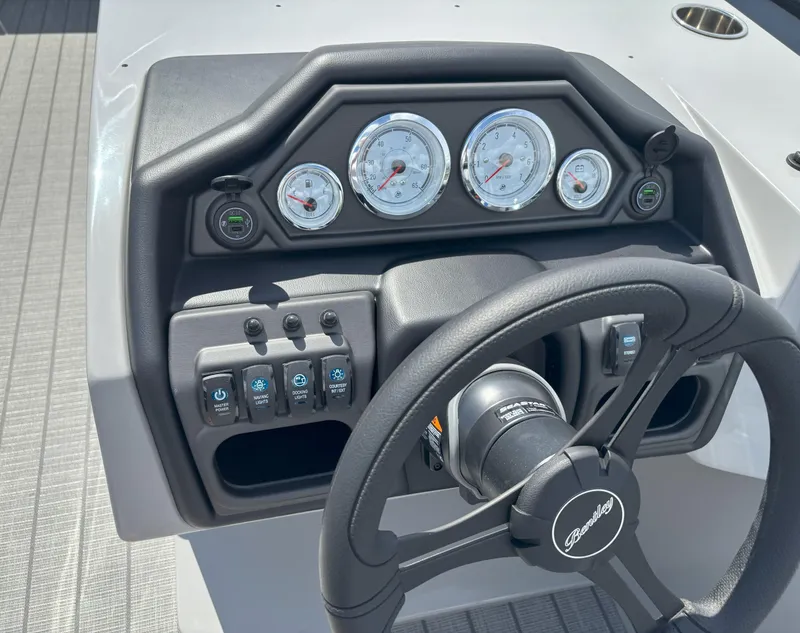 Slide: The Image of 2025 Bentley Pontoons Legacy 223 Cruise XL dashboard with steering wheel and gauges. - 19