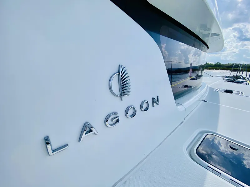 Slide: The Image of 2019 Lagoon 42 Owners Version yacht with sleek design and logo detail. - 16