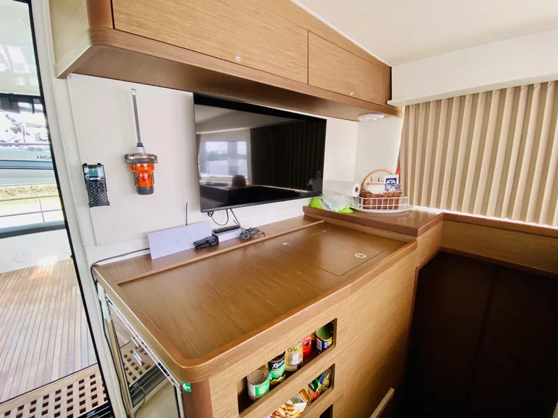 Slide: The Image of Interior of 2019 Lagoon 42 Owners Version yacht with modern kitchen and storage. - 22