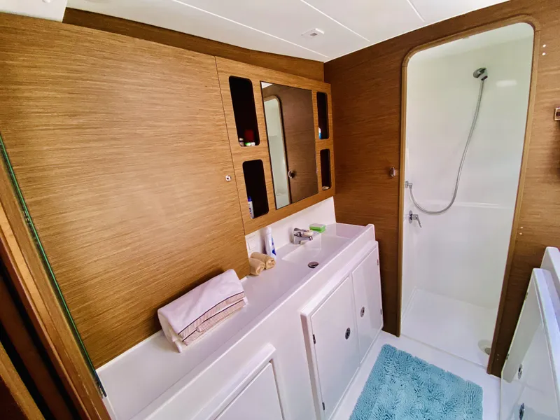 Slide: The Image of Luxurious bathroom in 2019 Lagoon 42 Owners Version yacht with modern fixtures and wooden accents. - 28