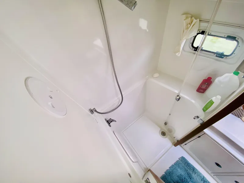 Slide: The Image of Bathroom interior of 2019 Lagoon 42 Owners Version yacht, featuring shower and window. - 29