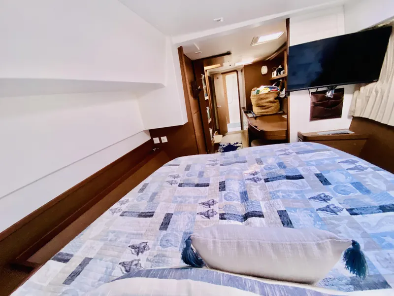 Slide: The Image of Luxurious interior of 2019 Lagoon 42 Owners Version catamaran bedroom with modern amenities. - 31