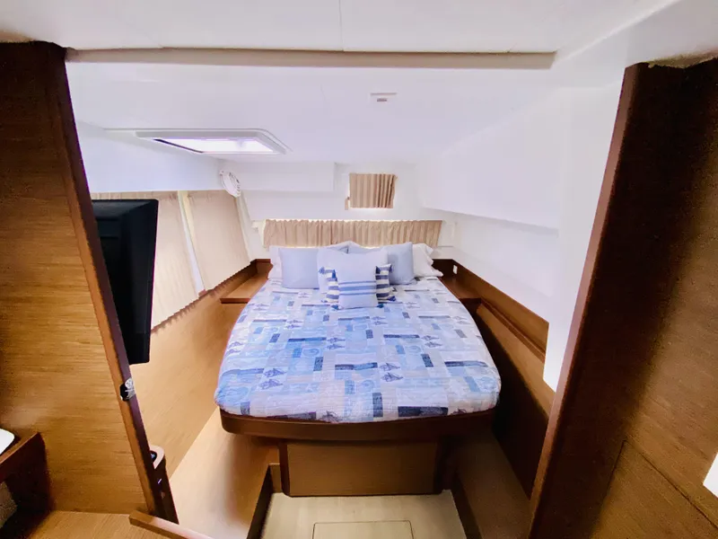 Slide: The Image of 2019 Lagoon 42 Owners Version cabin with cozy bed and modern interior design. - 33