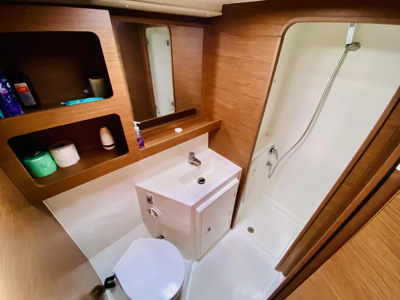Slide: The Image of 2019 Lagoon 42 Owners Version bathroom with shower, sink, and storage shelves. - 37