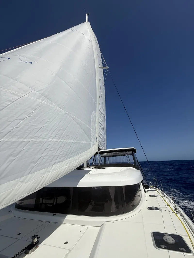 Slide: The Image of 2019 Lagoon 42 Owners Version sailing on open sea under clear blue sky. - 40