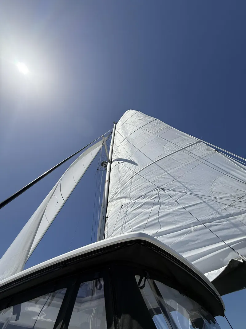Slide: The Image of Lagoon 42 Owners Version 2019 sailboat with sails unfurled against a clear blue sky. - 41