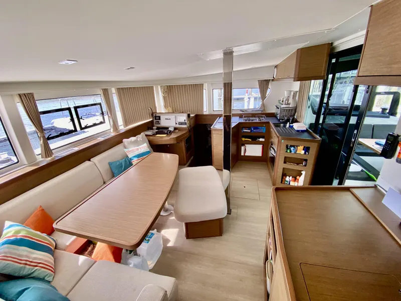 Slide: The Image of Luxurious interior of 2019 Lagoon 42 Owners Version catamaran with modern furnishings and ample natural light. - 18