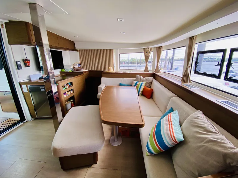 Slide: The Image of Spacious interior of 2019 Lagoon 42 Owners Version catamaran with modern seating and colorful cushions. - 21
