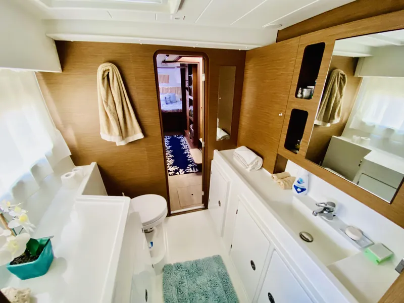 Slide: The Image of Luxurious bathroom in 2019 Lagoon 42 Owners Version catamaran, featuring modern fixtures and ample storage. - 30