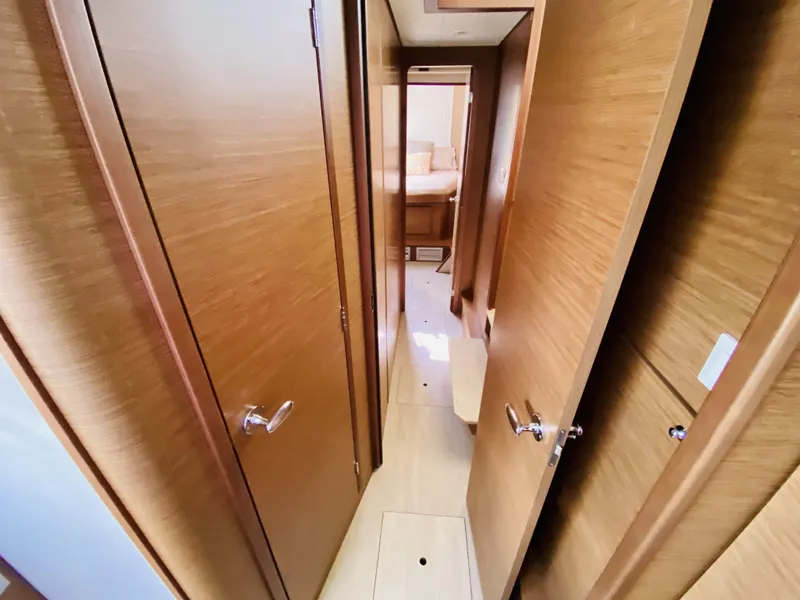 Slide: The Image of Interior hallway of 2019 Lagoon 42 Owners Version yacht, featuring wooden doors and modern design. - 35