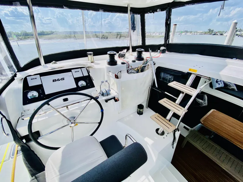 Slide: The Image of Helm of 2019 Lagoon 42 Owners Version catamaran with B&G navigation system and seating. - 4