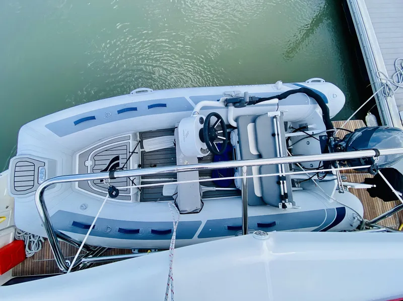 Slide: The Image of Overhead view of a 2019 Lagoon 42 Owners Version yacht with attached dinghy. - 42