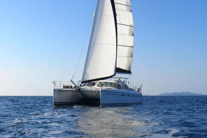 Slide: The Image of Sailing catamaran Privilege 435, 2006 model, cruising on open sea under clear blue sky. - 0