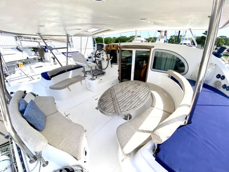 Slide: The Image of Spacious 2006 Privilege 435 yacht deck with seating and steering area. - 14