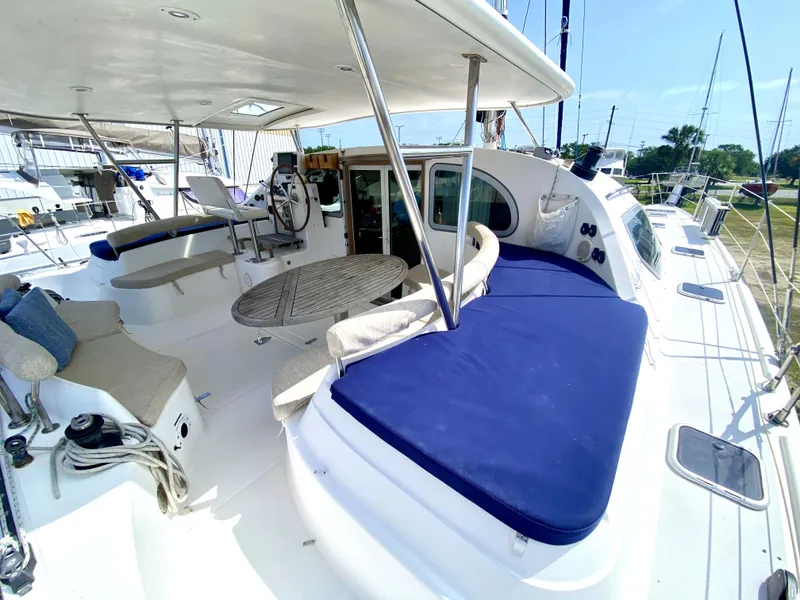 Slide: The Image of Spacious deck of 2006 Privilege 435 catamaran with blue cushions and seating area. - 15