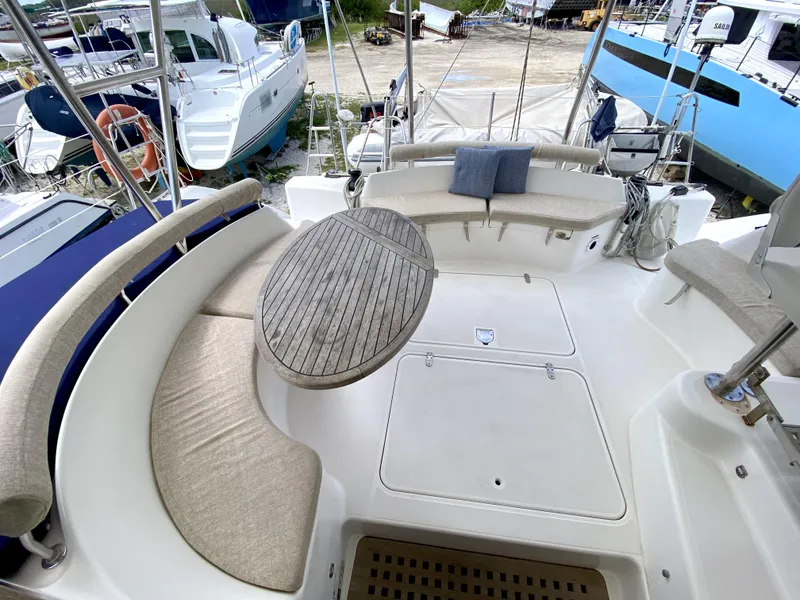 Slide: The Image of Spacious deck of 2006 Privilege 435 yacht with cushioned seating and wooden table. - 17