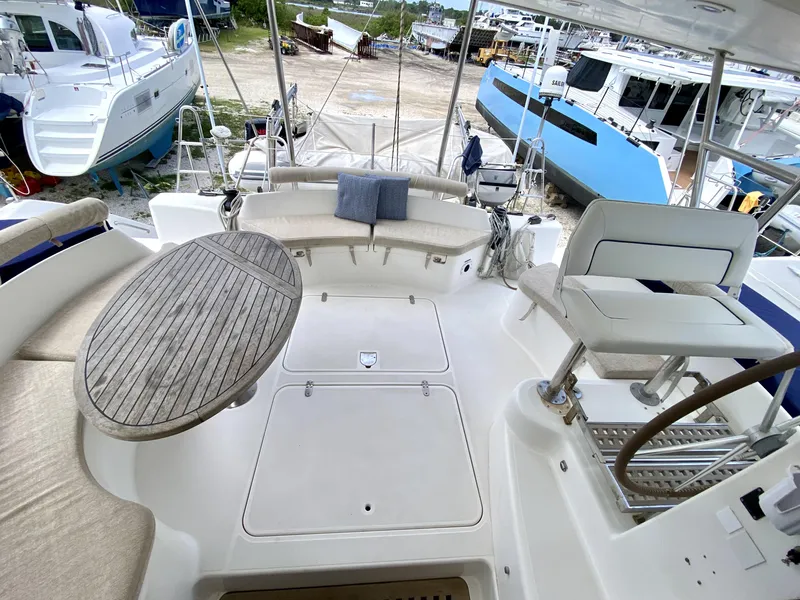 Slide: The Image of Spacious deck of 2006 Privilege 435 yacht with seating and wooden table. - 18