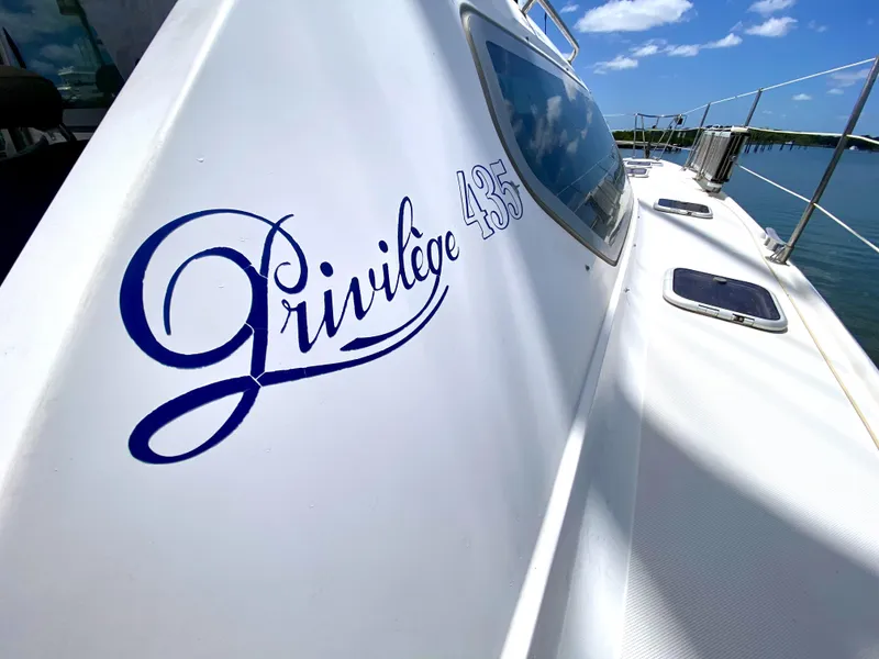 Slide: The Image of Privilege 435 yacht, 2006 model, docked under clear blue sky. - 19