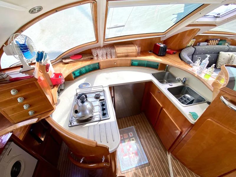 Slide: The Image of Luxurious 2006 Privilege 435 yacht kitchen with modern amenities and elegant wood finish. - 25