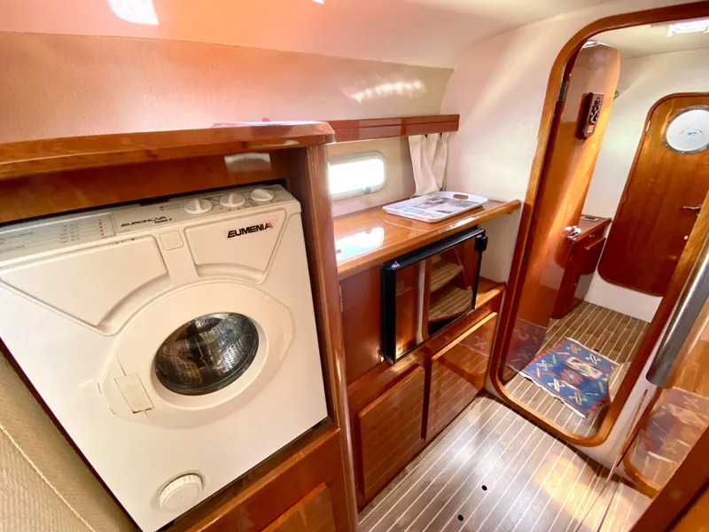 Slide: The Image of Interior of 2006 Privilege 435 yacht with washing machine and wooden cabinetry. - 27