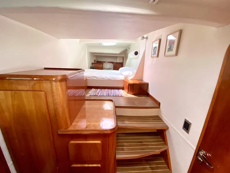 Slide: The Image of Luxurious 2006 Privilege 435 yacht interior with wooden finishes and cozy bedroom. - 28