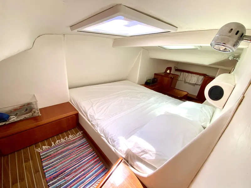 Slide: The Image of 2006 Privilege 435 yacht cabin with bed, skylight, and wooden furnishings. - 29