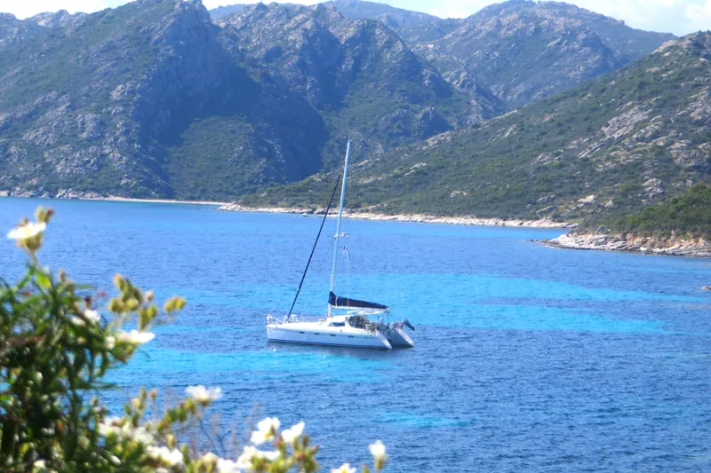 Slide: The Image of Sailboat Privilege 435 (2006) anchored in clear blue waters with mountainous backdrop. - 3