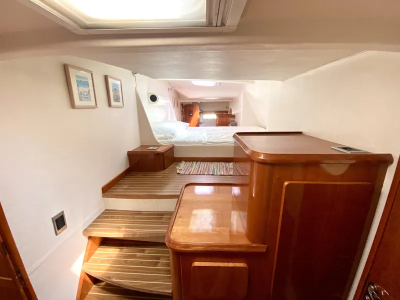 Slide: The Image of Luxurious 2006 Privilege 435 yacht interior with wooden steps and cozy bedroom. - 32