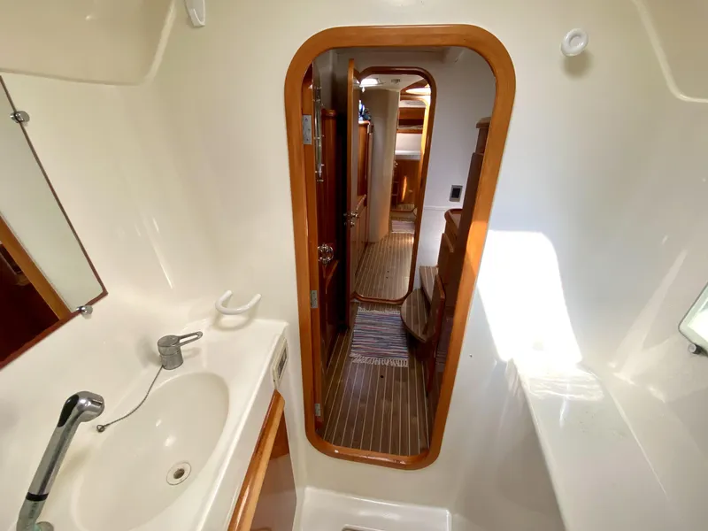 Slide: The Image of Interior of 2006 Privilege 435 yacht, featuring a bathroom with sink and wooden door. - 34