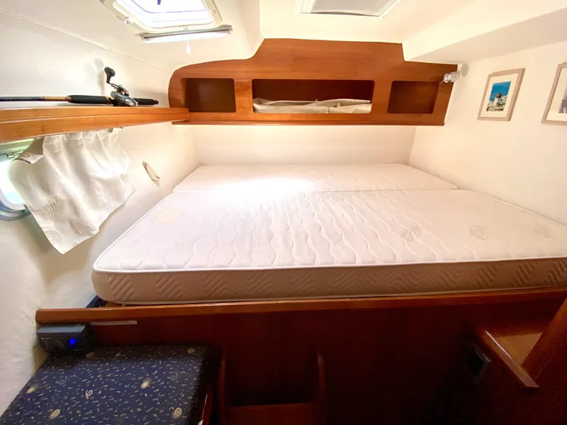 Slide: The Image of Cabin interior of 2006 Privilege 435 yacht with bed and wooden storage. - 39