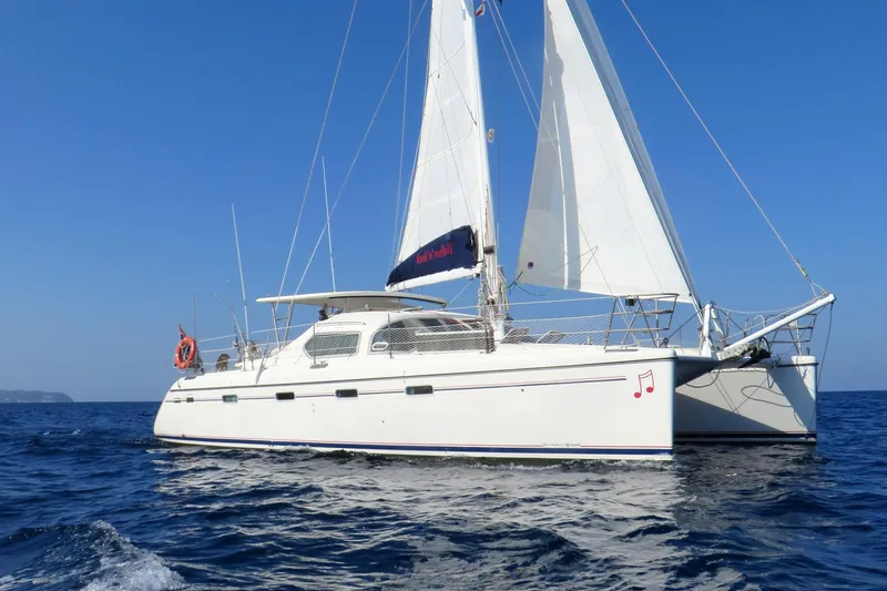 Slide: The Image of Sailing catamaran Privilege 435, 2006 model, cruising on open sea under clear blue sky. - 5
