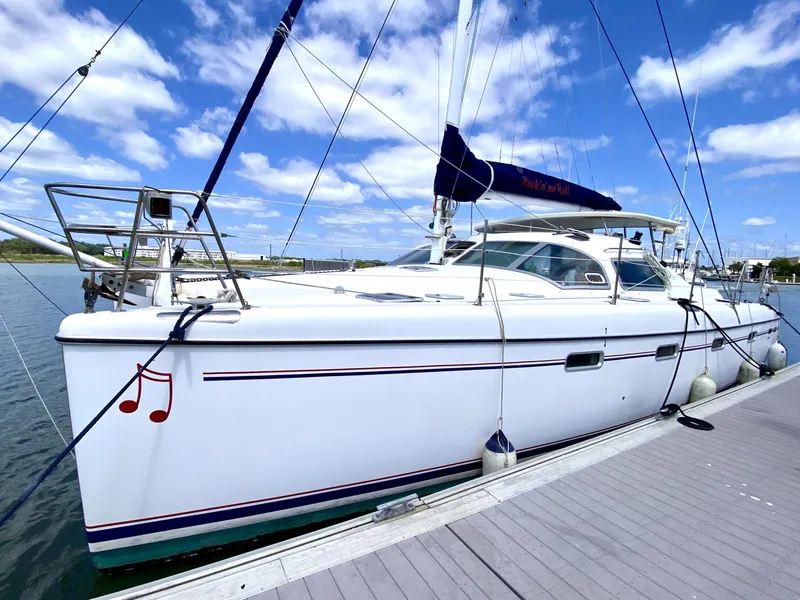 Slide: The Image of Sailing catamaran Privilege 435, 2006 model, docked under a clear blue sky. - 6