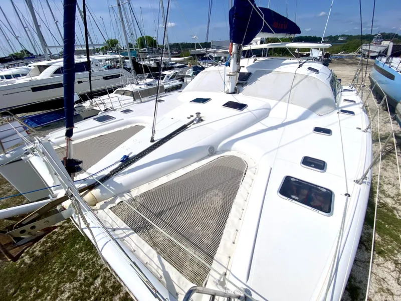 Slide: The Image of 2006 Privilege 435 catamaran docked, showcasing spacious deck and sleek design. - 9