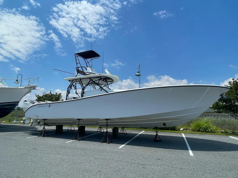 Slide: The Image of 2008 Yellowfin 42 boat on stands in a parking lot under a blue sky. - 10