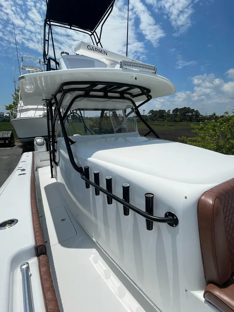 Slide: The Image of 2008 Yellowfin 42 boat with sleek design, white exterior, and advanced navigation equipment. - 15