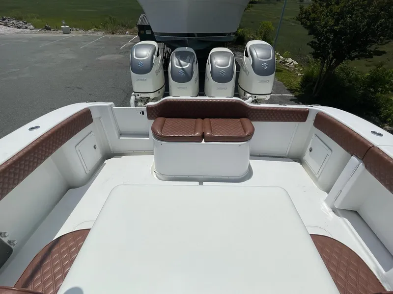 Slide: The Image of 2008 Yellowfin 42 boat interior with brown seating and four outboard motors. - 16