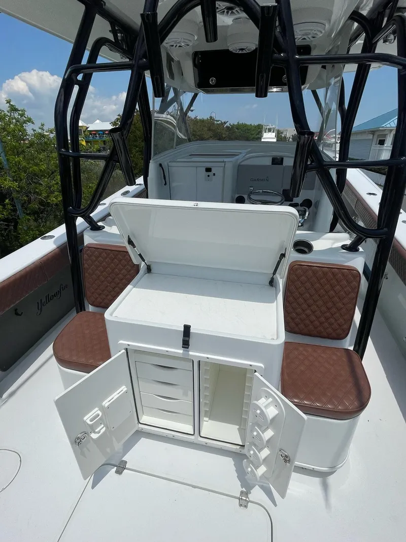 Slide: The Image of 2008 Yellowfin 42 boat interior with open storage compartments and cushioned seating. - 17