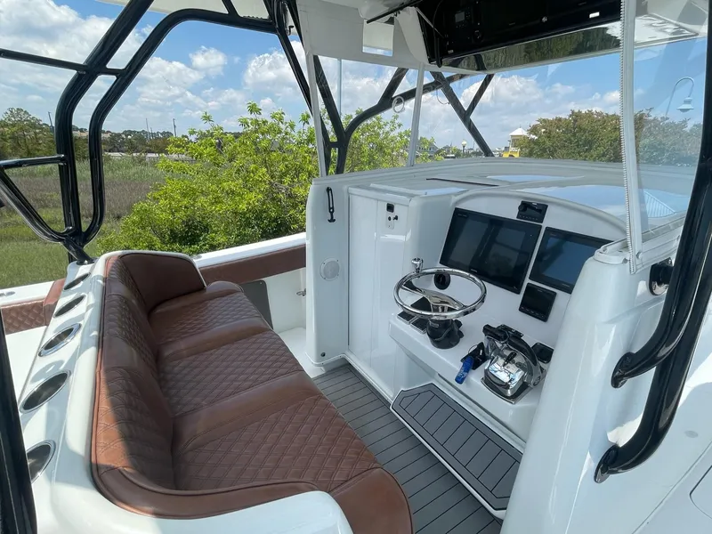 Slide: The Image of 2008 Yellowfin 42 boat interior with brown seating and modern control panel. - 20