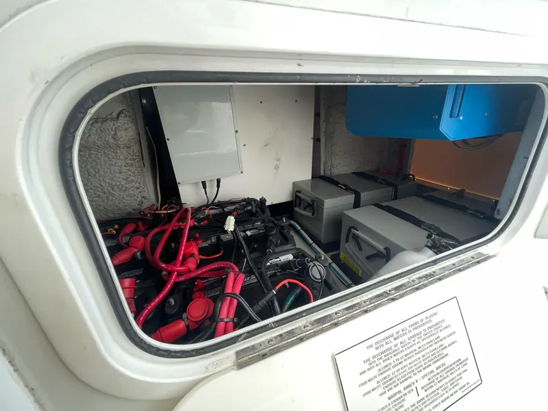 Slide: The Image of Electrical compartment of a 2008 Yellowfin 42 boat, featuring batteries and wiring. - 23