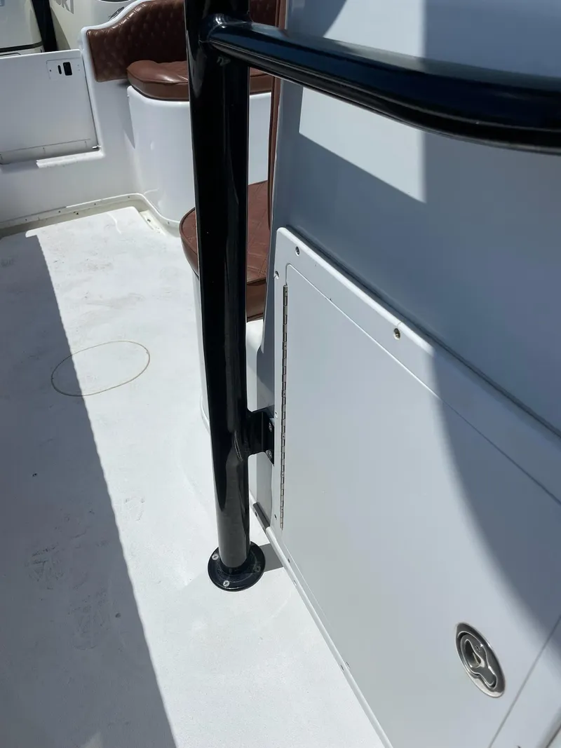 Slide: The Image of 2008 Yellowfin 42 boat interior with black railing and white storage compartment. - 34