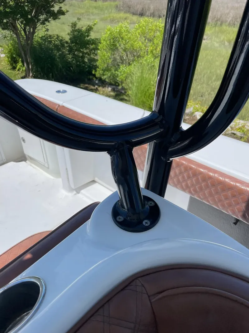 Slide: The Image of 2008 Yellowfin 42 boat interior with black railings and brown seating. - 36