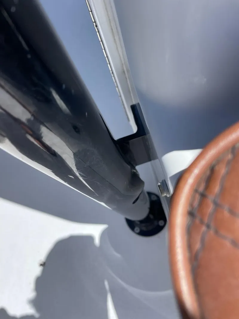 Slide: The Image of Close-up of a 2008 Yellowfin 42 boat detail, featuring a polished metal and leather component. - 37