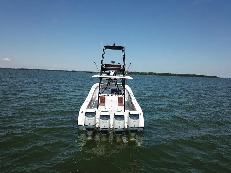 Slide: The Image of 2008 Yellowfin 42 boat with multiple outboard engines on open water. - 4