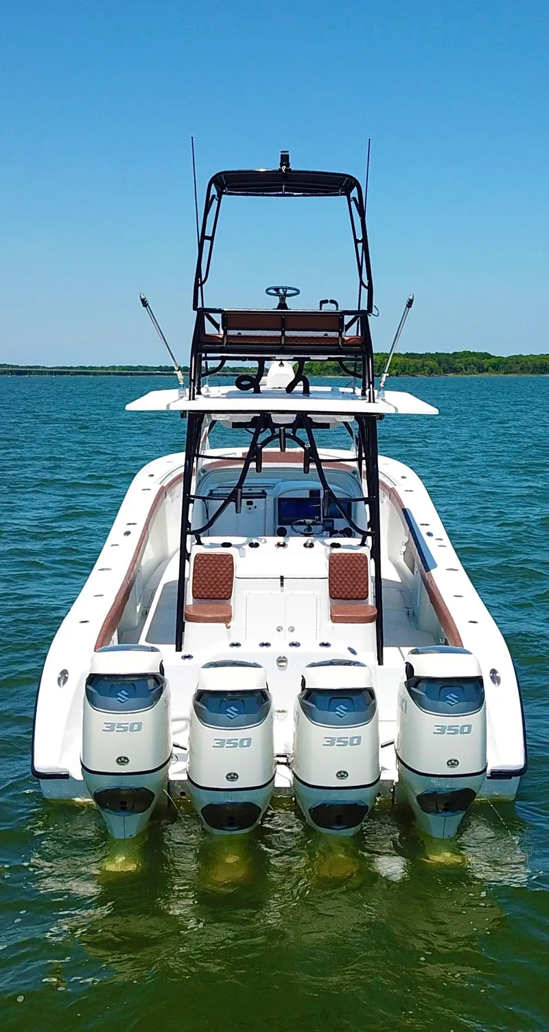 Slide: The Image of 2008 Yellowfin 42 boat with four powerful engines on a calm lake. - 6