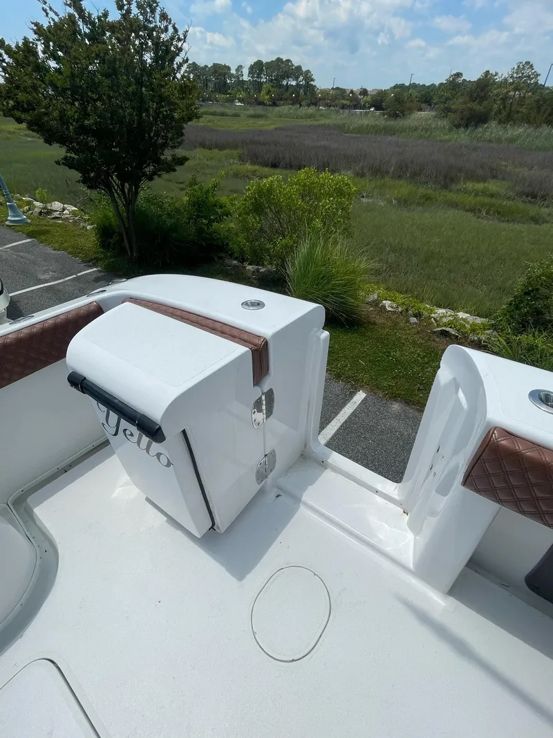 Slide: The Image of 2008 Yellowfin 42 boat deck with storage, overlooking lush greenery and blue sky. - 8