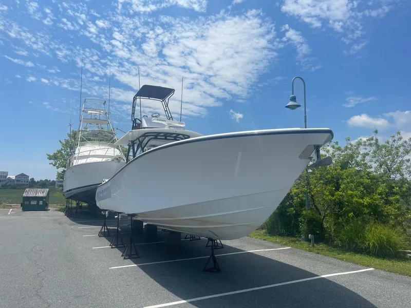 Slide: The Image of 2008 Yellowfin 42 boat on stands under a clear blue sky. - 9